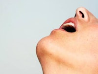 a close up of a woman's mouth with her mouth open