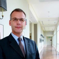 a man in a suit and tie standing in a hallway